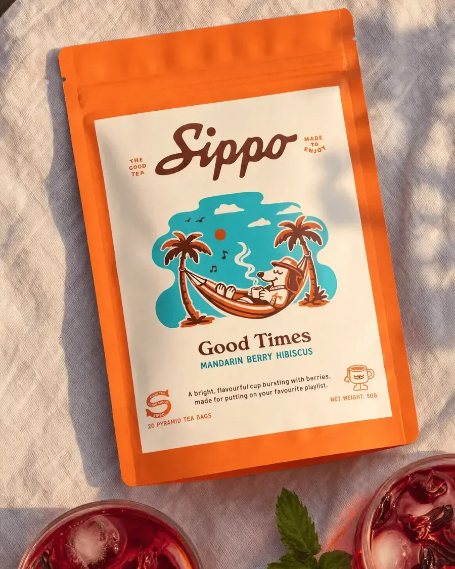 A Sippo Good Times tea pack shot close, steam and texture across the frame.